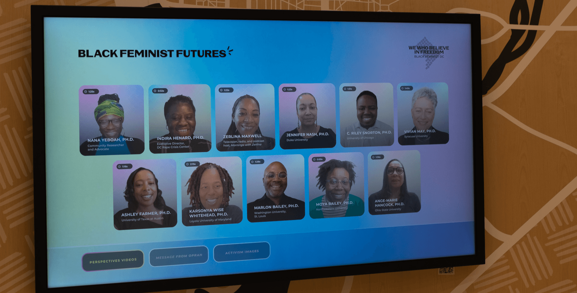 A screen displaying faces of black feminist icons